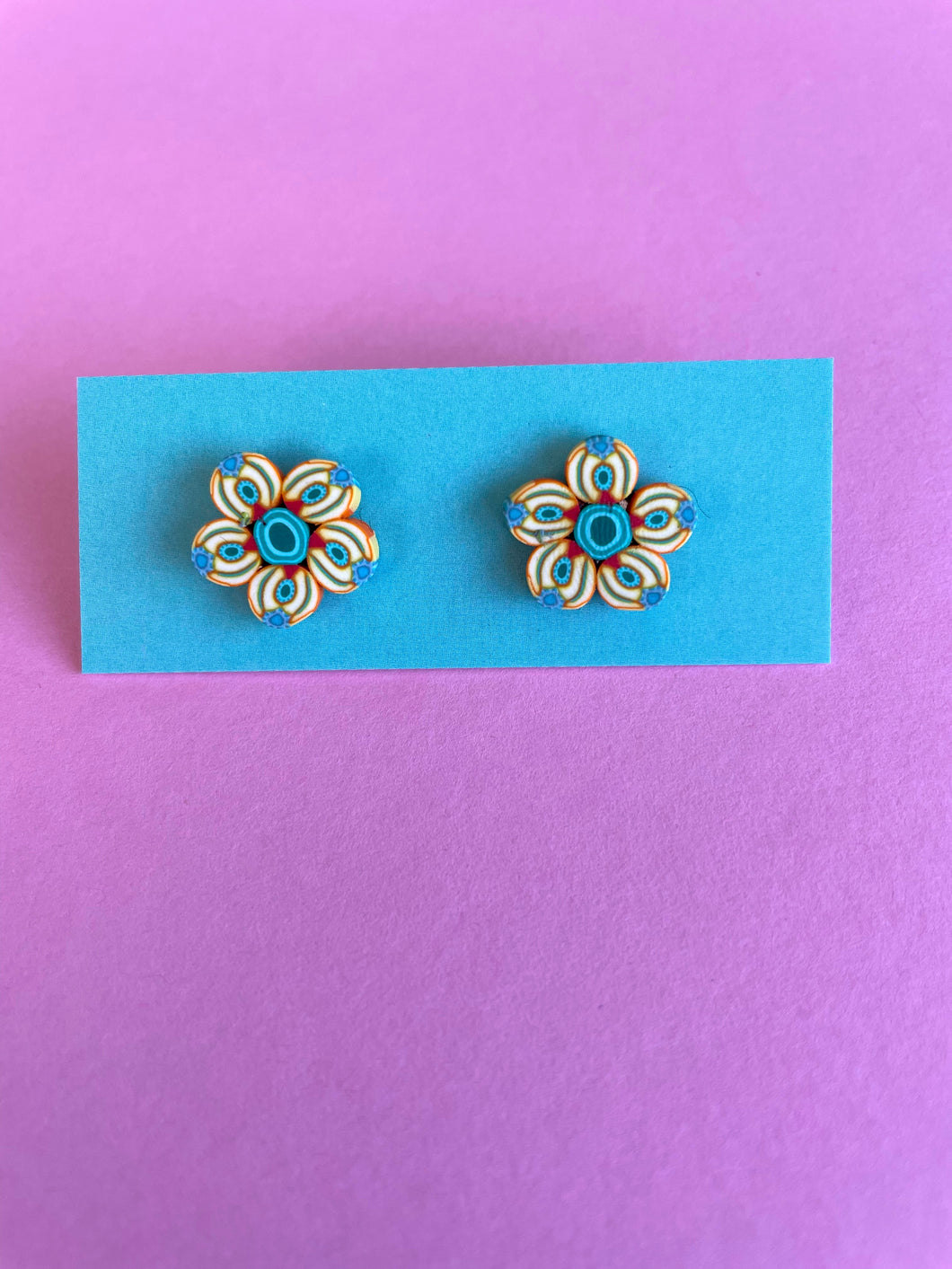 Stud earrings in yellow and blue flower shape