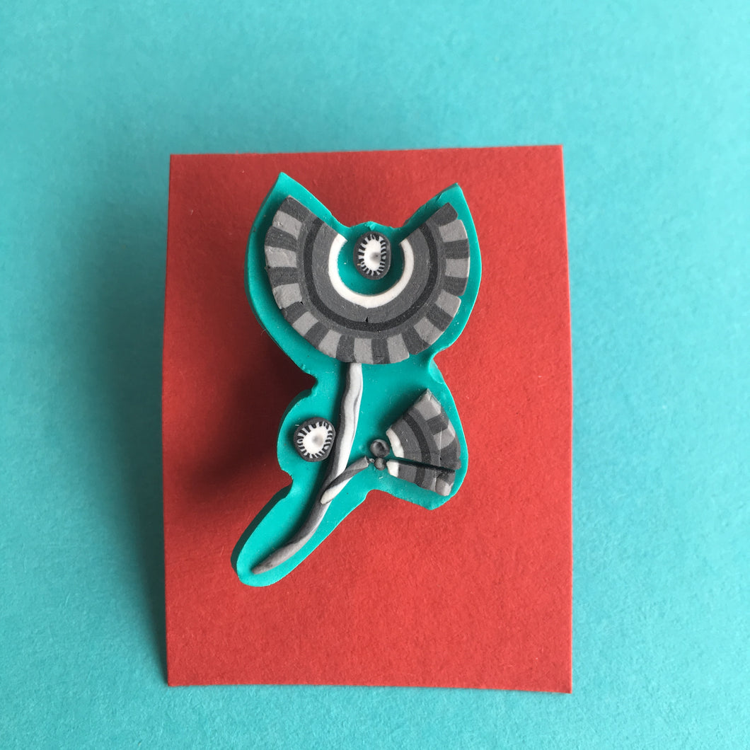 Grey on turquoise flower brooch